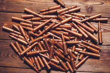 Bullets on wooden background.