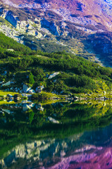 Amazing alpine lake in the high mountains, sunrise. Beautiful fiord mountain, river, hiking scenic landscape, summertime.