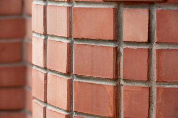 close-up view of red brick wall background, selective focus