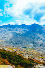 Beautiful alpine high mountains peaks, blue sky background. Amazing Mountain hiking paradise...