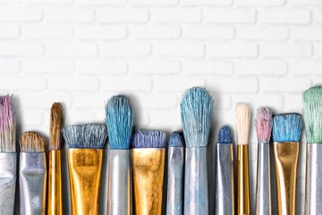 Row of artist paint brushes  on background