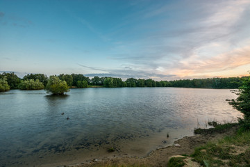 Lake and sand beach panorama. Nature landscape. Summer.