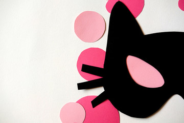 paper cat mask on white background with pink circles. Halloween, carnival, masquerade concept