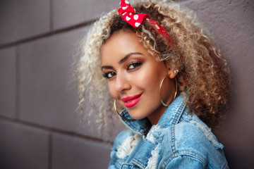 Portrait of beautiful smiling afro american woman in the street.