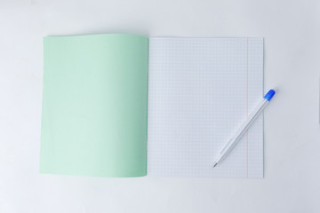close up.open school notebook in a cage and a ballpoint pen .photo with copy space
