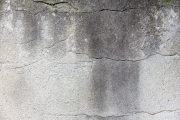 gray concrete wall with  deep cracks for text and design