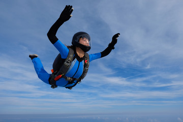 Skydiving. Girl is in the sky.