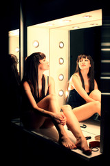 beautiful sexy girl in a corset in a photo studio