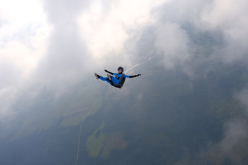 Skydiving. Girl is in the sky.