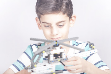 Boy creates a diy mechanical helicopter model. STEM education concept