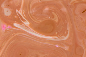 Fluid art. Abstract multicolored background on liquid. Orange spots of colors. Blurred pattern for designer. Holographic texture. Contemporary Art