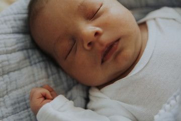 Infant baby fast asleep on the bed