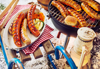 Platter of sausages on top of wooden plank bench