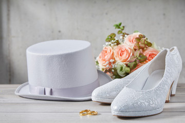 Large bouquet of flowers next to hat and shoes