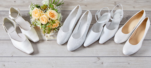 Four pairs of different white wedding shoes