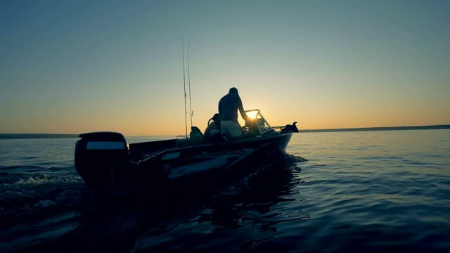 Sunrise scenery with a motorboat driven by two men