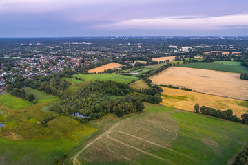 Naklejka premium Aerial view of amazing sunset over the park in Germany. Hill and lake from birds eye view. 