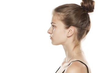 Profile of young serious woman on white background