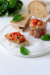 Rye bread toasts and glass jar with eggplant caviar. Vegetable appetizer or antipasti. Healthy food concept