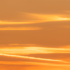 Squared image of beautiful sunset sky with soft clouds. Orange, pastel tone