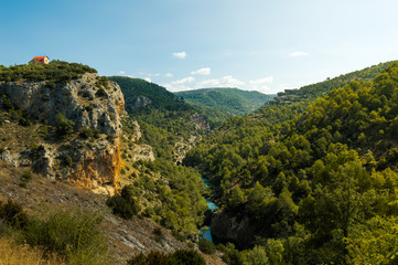 Beautiful top view of a lonely and cute house in a mountain cliff next to the river Jucar in...