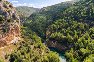 Top view of the mountains and the valley of the river Jucar in Cuenca, Spain. Views from the lookout Ventano del Diablo on a sunny day.