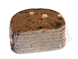 Black rye bread with pieces of fruit and nuts in a transparent cellophane package