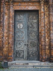 Vintage old painted metal door of the brick cathedral