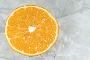 Orange fruit slice isolated on white stone,Cose up.