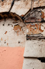 Texture of old plaster wall with red and pink bricks background. Old house in the centre of the European city.