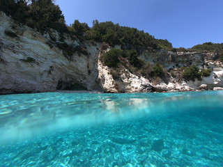 Sea level underwater photo of tropical caribbean paradise turquoise beach in exotic island located in an ocean