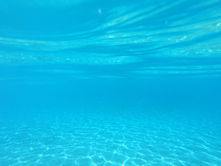 Underwater photo of tropical paradise turquoise exotic beach of Voutoumi with sail boats docked in island of Antipaxos, Ionian, Greece