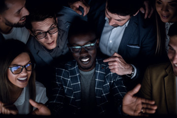 close up.a successful business team looks at the computer screen with passion