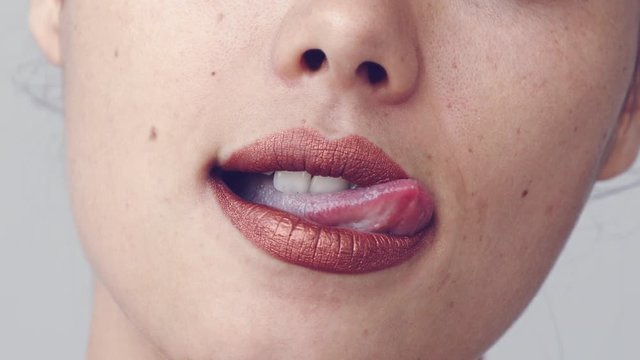 Woman moving her tongue over lips