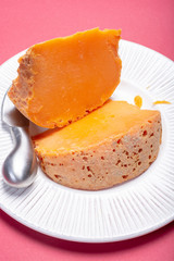 Two pieces of native French aged cheese Mimolette, produced in Lille with greyish curst made by special cheese mites