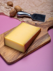Piece of aged Comte or Gruyere de Comte, AOC French cheese made from unpasteurized cow's milk in the Franche-Comte region of eastern France with traditional methods of production.