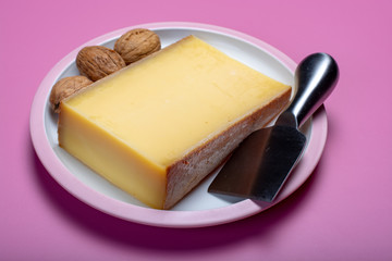 Piece of aged Comte or Gruyere de Comte, AOC French cheese made from unpasteurized cow's milk in the Franche-Comte region of eastern France with traditional methods of production.