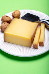 Piece of aged Comte or Gruyere de Comte, AOC French cheese made from unpasteurized cow's milk in the Franche-Comte region of eastern France with traditional methods of production.
