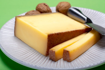 Piece of aged Comte or Gruyere de Comte, AOC French cheese made from unpasteurized cow's milk in the Franche-Comte region of eastern France with traditional methods of production.