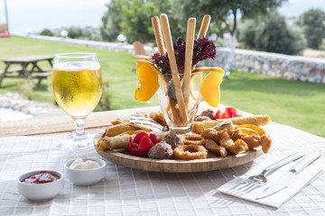 Fresh beer snacks assortment on wooden board