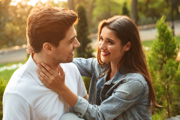 Obraz premium Loving couple walking outdoors while hugging.