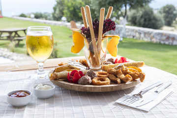 Fresh beer snacks assortment on wooden board