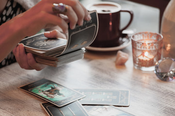 Woman is reading Tarot cards in cafe