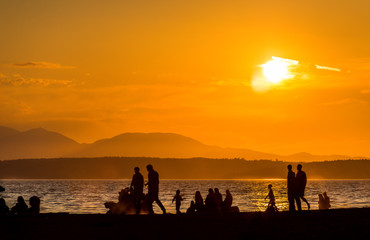 scene view of silhouette people on the beach with sunset,on summer,Seattle,usa.