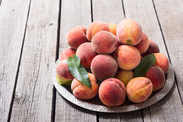 Ripe peaches fruit on rustic background