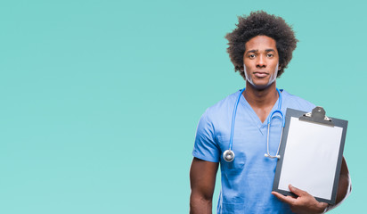 Afro american surgeon doctor holding clipboard man over isolated background with a confident expression on smart face thinking serious