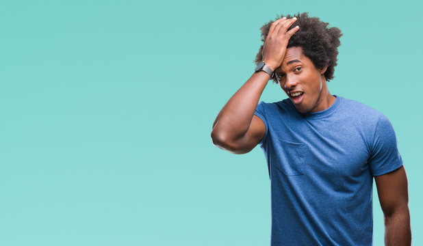 Afro american man over isolated background surprised with hand on head for mistake, remember error. Forgot, bad memory concept.