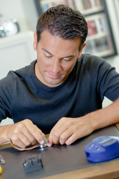handsome man repairing watch