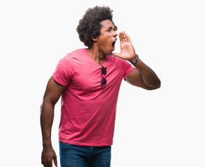 Afro american man over isolated background shouting and screaming loud to side with hand on mouth. Communication concept.