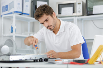 man installing induction hobs in a kitchen